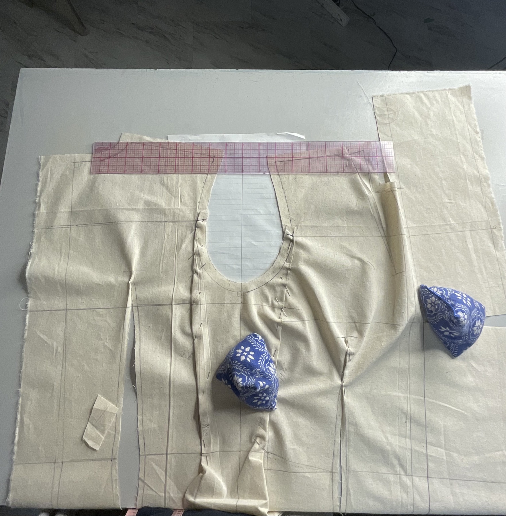 Pattern paper and tools gathered across a studio table.